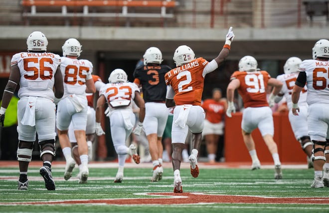 Texas Orange team defensive back Derek Williams Jr. (2) celebrates as his team runs in a touchdown off a pass interception in the first quarter of the Longhorns' spring Orange and White game at Darrell K Royal Texas Memorial Stadium in Austin, Texas, April 20, 2024.