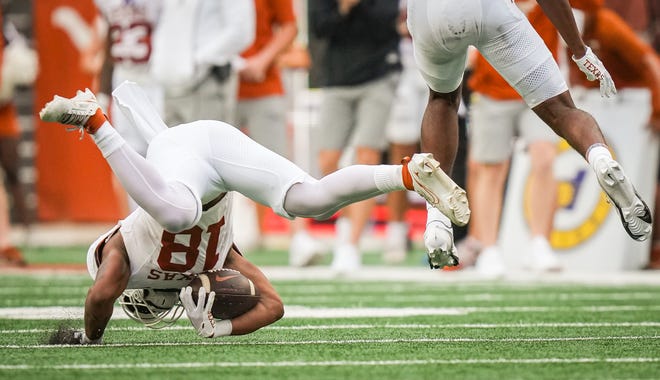 Texas White team wider receiver Ryan Niblett (18) catches the ball near the ground as Orange team defensive back Jelani McDonald (25) leaps over him in the second quarter of the Longhorns' spring Orange and White game at Darrell K Royal Texas Memorial Stadium in Austin, Texas, April 20, 2024.