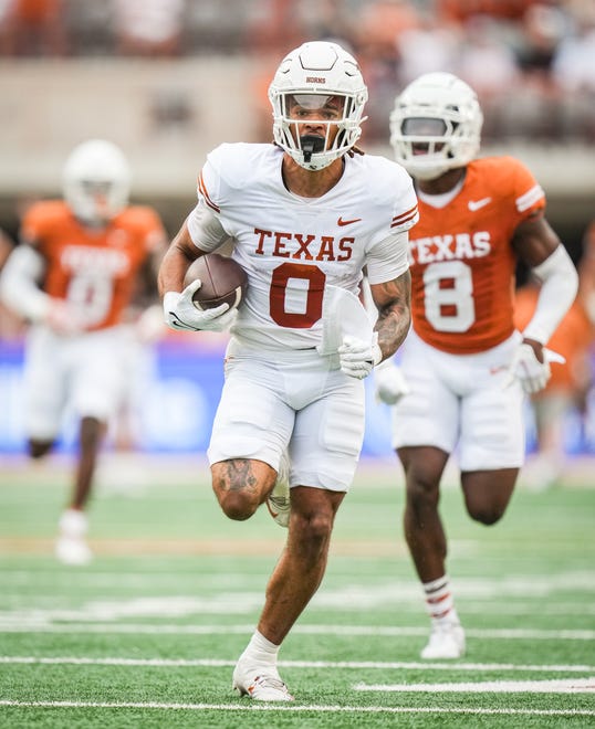 Texas White team wide receiver DeAndre Moore Jr. (0) runs the ball in for a touchdown in the first quarter of the Longhorns' spring Orange and White game at Darrell K Royal Texas Memorial Stadium in Austin, Texas, April 20, 2024.