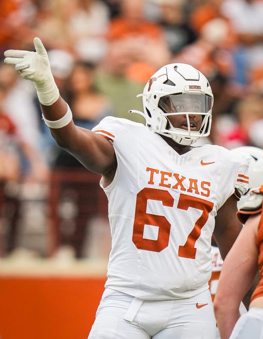 Texas White team offensive lineman Malik Agbo (67) signals for a call in the third quarter of the Longhorns' spring Orange and White game at Darrell K Royal Texas Memorial Stadium in Austin, Texas, April 20, 2024.
