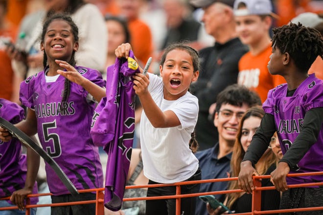 Young Texas Longhorns fans yell for former Longhorn and current Atlanta Falcons running back Bijan Robinson, hoping for an autograph, in the fourth quarter of the Longhorns' spring Orange and White game at Darrell K Royal Texas Memorial Stadium in Austin, Texas, April 20, 2024.