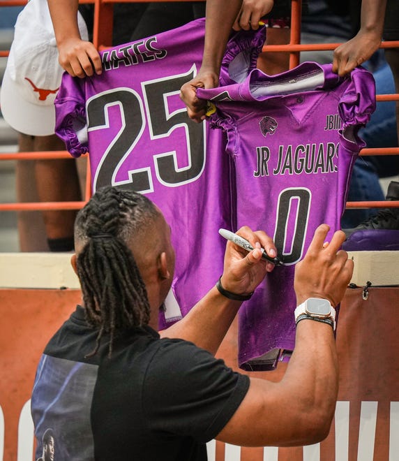 Former Texas Longhorn and current Atlanta Falcons running back Bijan Robinson signs autographs for fans in the fourth quarter of the Longhorns' spring Orange and White game at Darrell K Royal Texas Memorial Stadium in Austin, Texas, April 20, 2024.