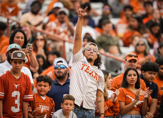 A fan puts his 'Horns Up' in the third quarter of the Longhorns' spring Orange and White game at Darrell K Royal Texas Memorial Stadium in Austin, Texas, April 20, 2024.
