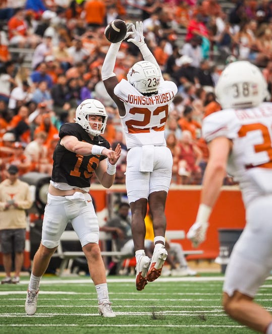 Texas White team defensive back Jordon Johnson-Rubell (23) misses intercepting a pass from Texas quarterback Cole Lourd (19) in the fourth quarter of the Longhorns' spring Orange and White game at Darrell K Royal Texas Memorial Stadium in Austin, Texas, April 20, 2024.