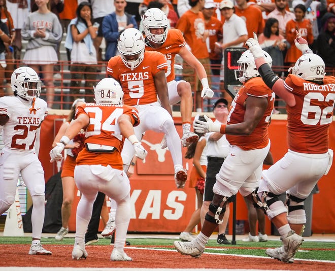 The Texas Orange team celebrate a touchdown catch by wide receiver Ryan Wingo (5) in the fourth quarter of the Longhorns' spring Orange and White game at Darrell K Royal Texas Memorial Stadium in Austin, Texas, April 20, 2024.