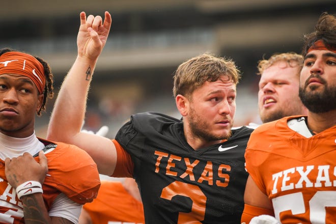 Texas Longhorns quarterback Quinn Ewers puts his 'Horns Up' for "The Eyes of Texas" following the Longhorns' spring Orange and White game at Darrell K Royal Texas Memorial Stadium in Austin, Texas, April 20, 2024.