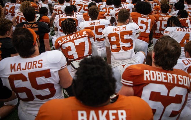 The Texas Longhorns gather on the field following the Longhorns' spring Orange and White game at Darrell K Royal Texas Memorial Stadium in Austin, Texas, April 20, 2024.