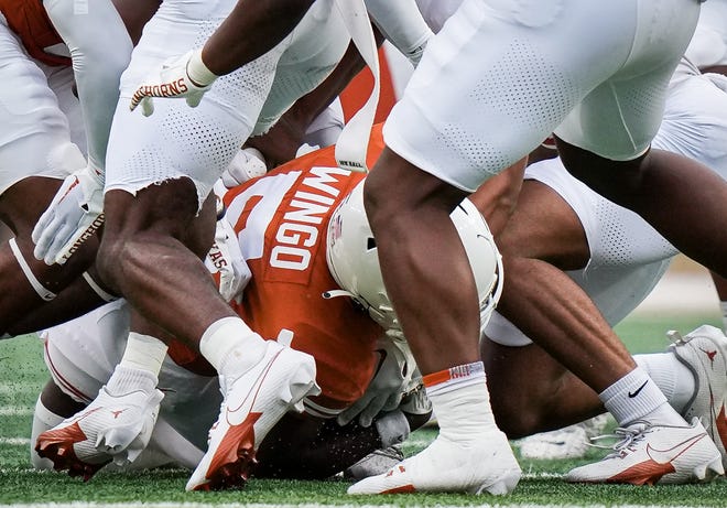 Texas Orange team wide receiver Ryan Wingo (5) goes down with the ball during the Longhorns' spring Orange and White game at Darrell K Royal Texas Memorial Stadium in Austin, Texas, April 20, 2024.