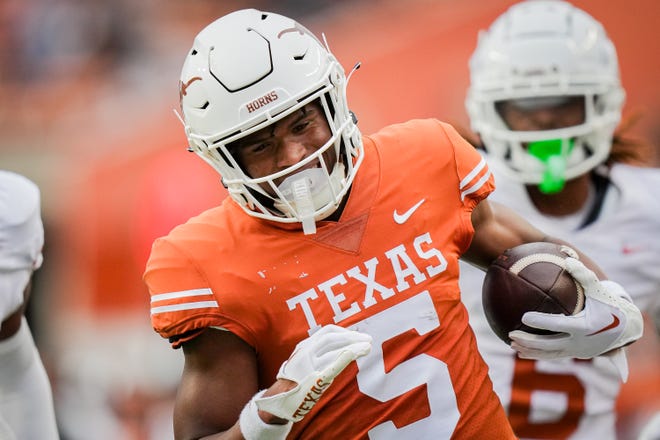 Texas Orange team wide receiver Ryan Wingo (5) runs the ball in for a touchdown during the Longhorns' spring Orange and White game at Darrell K Royal Texas Memorial Stadium in Austin, Texas, April 20, 2024.