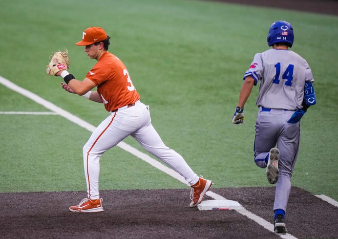 Texas Longhorns infielder Casey Borba (31) catches the ball at first base to get UT Arlington Mavericks outfielder Jacskon Hill (14) out in the third inning of the Longhorns' game against the Mavericks at UFCU Disch-Falk Field, Tuesday, April 23, 2024. Rodriguez is acting head coach while David Pierce is suspended.
