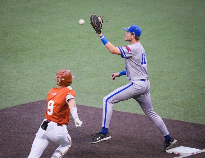 UT Arlington Mavericks infielder Tyce Armstrong (11) catches the ball at first base to get Texas Longhorns infielder Jared Thomas (9) out in the fourth inning of the Longhorns' game against the UT Arlington Mavericks at UFCU Disch-Falk Field, Tuesday, April 23, 2024. Rodriguez is acting head coach while David Pierce is suspended.