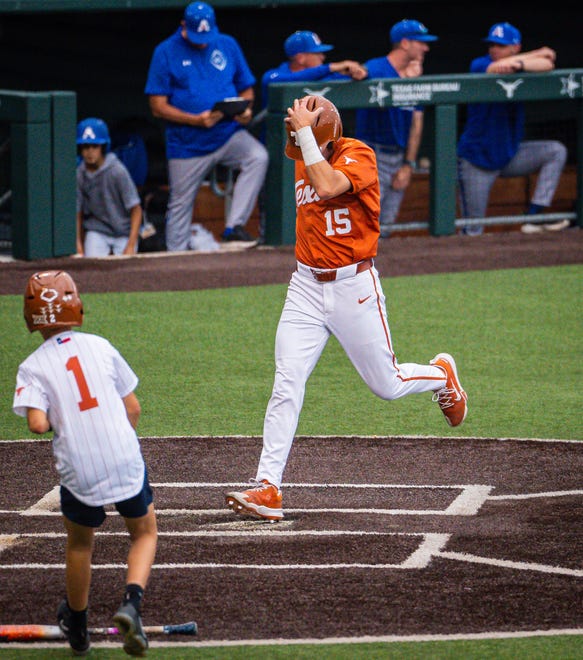 Texas Longhorns catcher Peyton Powell (15) runs over home plate to score the first point of the game for Texas in the first inning of the Longhorns' game against the UT Arlington Mavericks at UFCU Disch-Falk Field, Tuesday, April 23, 2024. Rodriguez is acting head coach while David Pierce is suspended.
