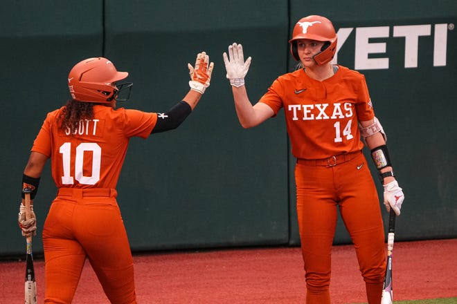Texas Longhorns player Mia Scott (10) and catcher Reeese Atwood (14) celebrate a score after a hit by Ashton Maloneey (7) during the game against Iowa State at Red and Charline McCombs Field on Friday, April 26, 2024 in Austin.